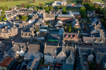 Fototapeta premium Aerial View of Businesses on the Main Street of Kingussie Scotland at Sunset