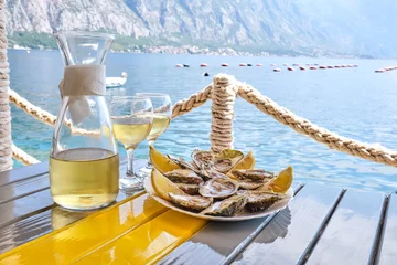 Oysters and white wine in a restaurant with a sea view © Nataliia Vyshneva