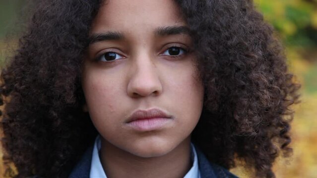Beautiful mixed race biracial African American girl teenager young woman looking sad depressed then happy smiling