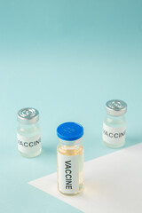 Above view of vaccine ampoules on pastel blue and white background with free space