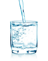 pouring water on a glass on white background
