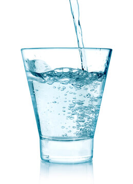 pouring water on a glass on white background