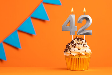 Candle number 42 - Cake birthday in orange background