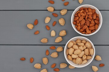 Peeled and shelled almonds, bitter almonds, on the table, gray background, for presentations