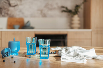 wood dining table with dishware, drink and berries