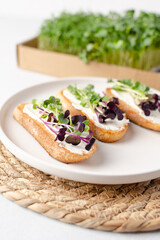 Healthy snacks or starter, appetizer with organic microgreens growing at home for healthy eating or for restaurant. Close up