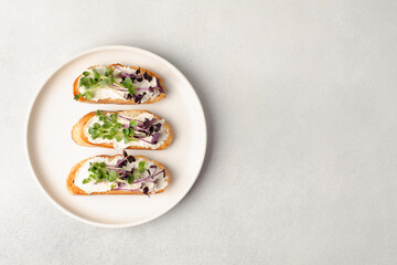 Healthy snacks or starter, appetizer with organic microgreens growing at home for healthy eating or for restaurant. Top view, copy space for text