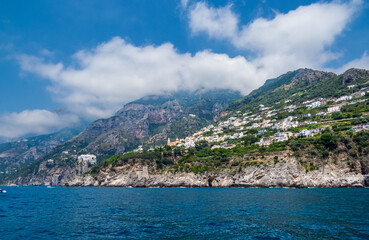 Fototapeta na wymiar Amalfi Coast from a boat, a beautiful view on a summer day, Italy
