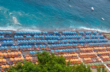 Door stickers Positano beach, Amalfi Coast, Italy From the top of Positano, panoramic photograph of the beach on a summer day with the beach umbrellas symmetrically placed and in the same colors. Amalfi Coast, Italy