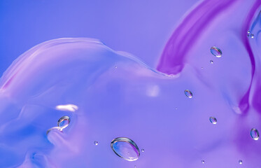Gel texture of cosmetic products. transparent cream on a blue lilac background with bubbles. macro...