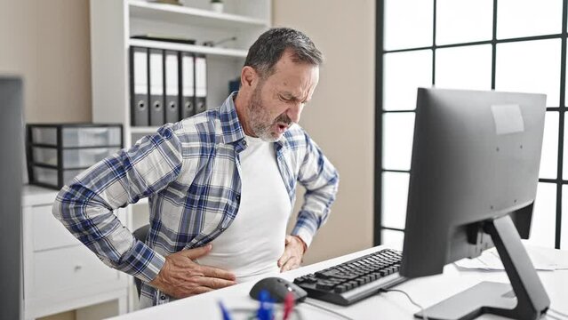 Middle age man business worker suffering for stomachache working at office