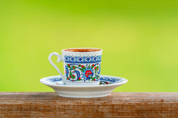 Sparkling Turkish coffee in a classic patterned Turkish Cup.