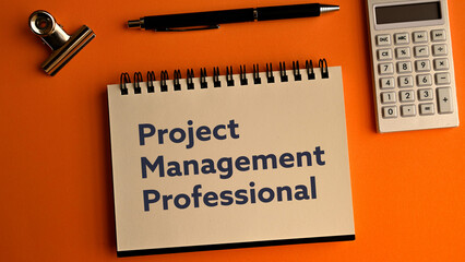 There is notebook with the word Project Management Professional. It is as an eye-catching image.