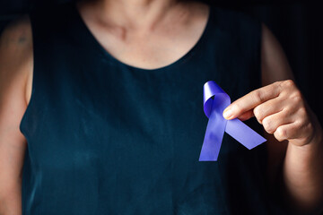 Hands holding purple ribbon symbol of Alzheimer disease, world Lupus. Day and world cancer day....