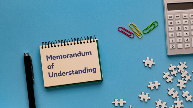 There is notebook with the word Memorandum of Understanding. It is as an eye-catching image.
