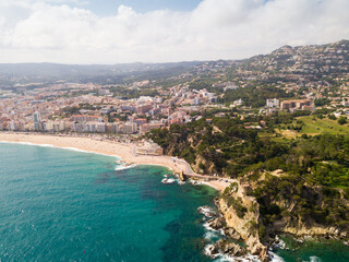 Fototapeta premium View from drone of Spanish town of Lloret de Mar on Mediterranean coast in summer day.