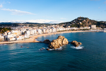 Scenic drone view of coastal Catalan town of Blanes overlooking white residential buildings and Sa...