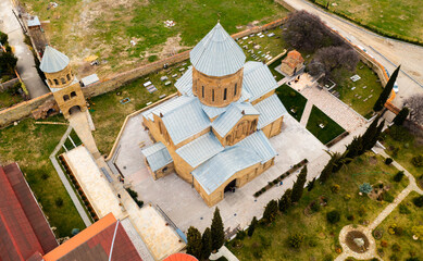 Aerial view of medieval Samtavro monastery complex with Transfiguration Church and Nunnery of St. Nino in small Georgian town of Mtskheta on spring day