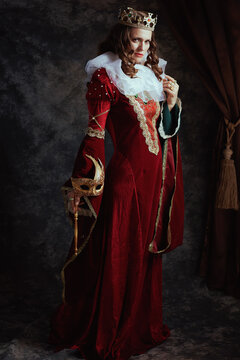 Full length portrait of insidious medieval queen in red dress