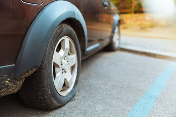 Closeup on car with flat tire in city