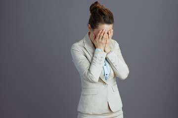 stressed young female employee in light business suit