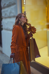 happy woman in orange trench coat