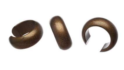 Fashion gold wooden bracelet with beautiful work detail is value. Luxury gold wooden bangle bracelet is fashion trend and fly in air. White background isolated