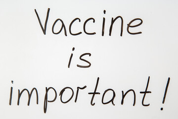 High resolution photo of Vaccine is important writing on white desk