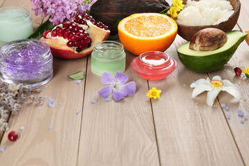 Homemade cosmetic products and fresh ingredients on wooden table, space for text. DIY beauty recipe