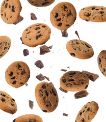 Delicious chocolate chip cookies and pieces of chocolate falling on white background