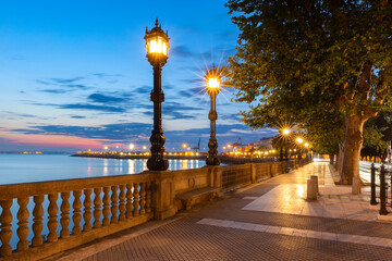 Old Embankment with beautiful lanterns at dawn in Cadiz, Andalusia, Spain