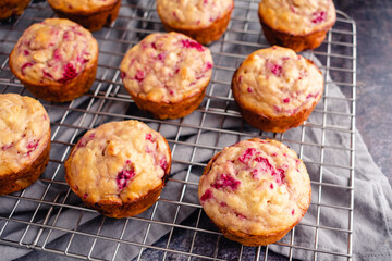 Freshly Baked Raspberry Muffins on a Wire Cooling Rack: Breakfast or dessert muffins made with fruit viewed from a high angle
