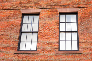 Brick buildings with windows symbolize strength, stability, and urban progress, capturing the essence of business and industry