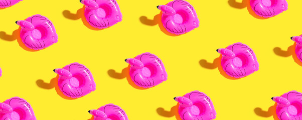 Obraz premium Summer concept with pink flamingo floats - flat lay