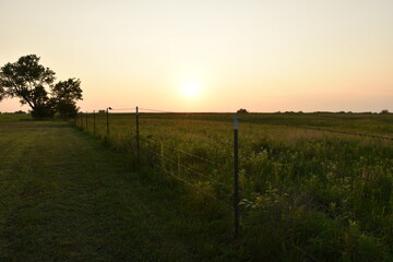 Fototapeta na wymiar Sunset Over a Rural Farm Field