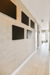 an empty room with tvs on the wall and wood flooring in front of white brick walls, as if there is no
