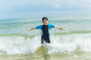 Happy child having fun on summer vacation. Child girl on the beach on sea shore.