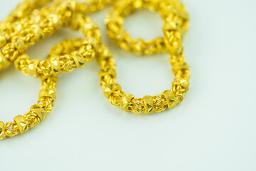 Detailed shot of luxury elegant gold necklace on a white background