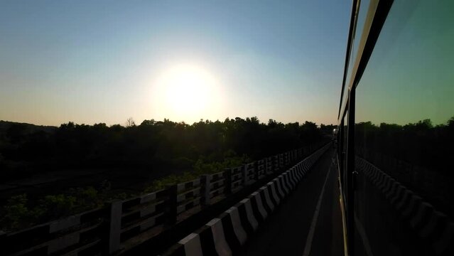travelling mumbai to malvan wide view from bus window in evening