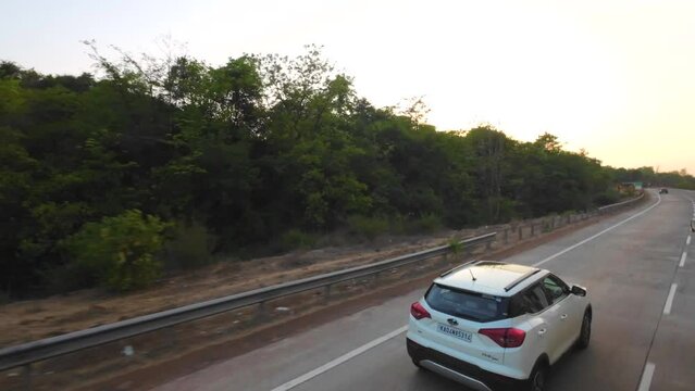 travelling mumbai to malvan wide view from bus window in evening