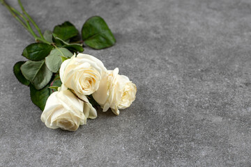 Beautiful bouquet of white roses placed on marble background