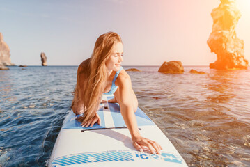 Woman sea sup. Close up portrait of happy young caucasian woman with long hair looking at camera...
