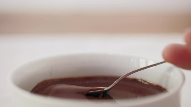 Eating chocolate pudding with spoon