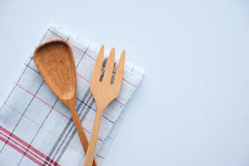  wooden cutlery fork and spoon on a chopping board on table 