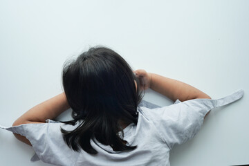  child head down on desk top view 