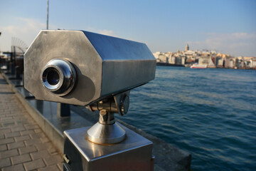 Coin-operated binoculars looking out over city ,