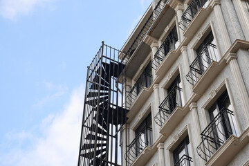 establish shot of a hotel building with balcony against blue sky 