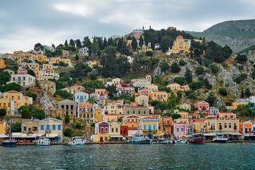 Naklejka premium Symi, a beautiful small Greek island near Rhodes, which is visited by many tourists due to its colorful houses