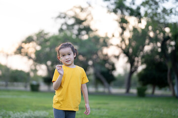 little asian girl exercise on the field