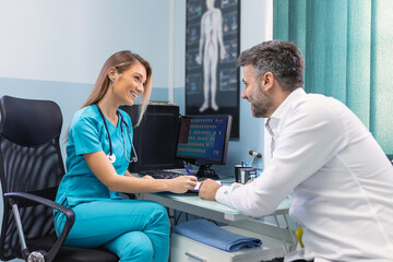 Serious man consulting with young female physician doctor at checkup meeting in hospital. Skilled general practitioner giving healthcare medical advices to patient.